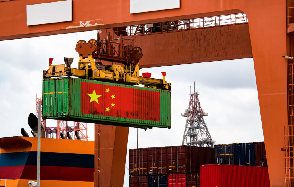 Container crane handling container box loading to truck in import export logistic zone